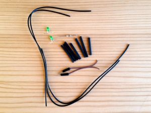 Materials used for festive tree lighting example - wires, LEDs, resistor, heat-shrink tubing cut to size